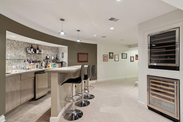 13 Wind Ridge Rd, South Barrington, IL 60010 - indoor wet bar with beverage cooler, stainless steel dishwasher, hanging light fixtures, recessed lighting, and light carpet