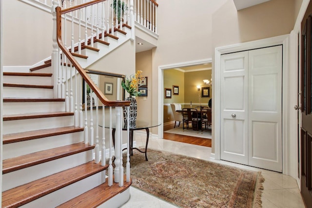 13 Wind Ridge Rd, South Barrington, IL 60010 - stairway featuring a towering ceiling and tile patterned floors