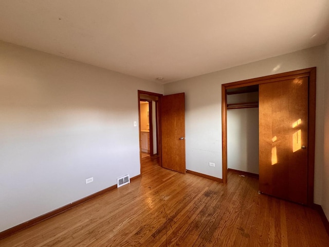 16850 School St, South Holland, IL 60473 - unfurnished bedroom with wood finished floors and a closet