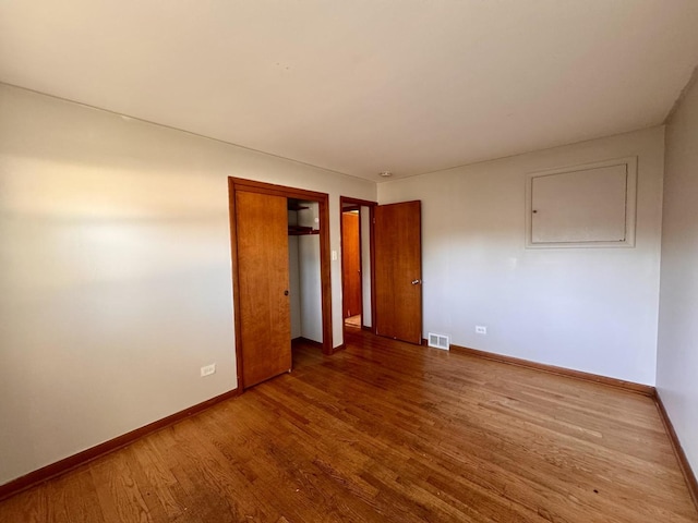 16850 School St, South Holland, IL 60473 - unfurnished bedroom with wood finished floors and a closet
