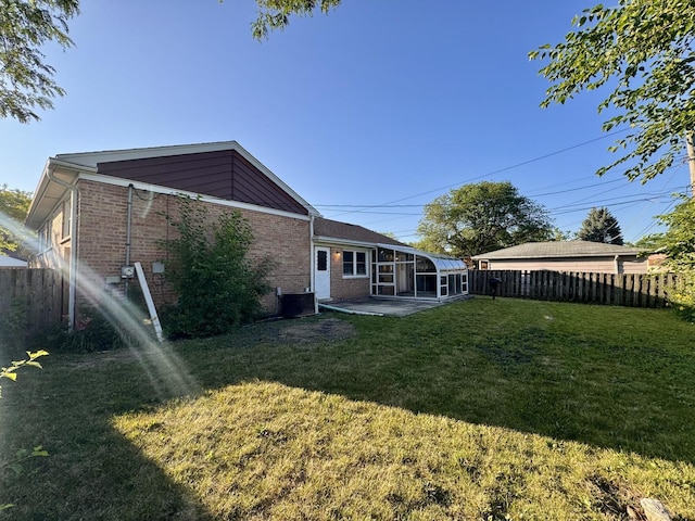 16850 School St, South Holland, IL 60473 - back of property featuring a sunroom, brick siding, and a patio