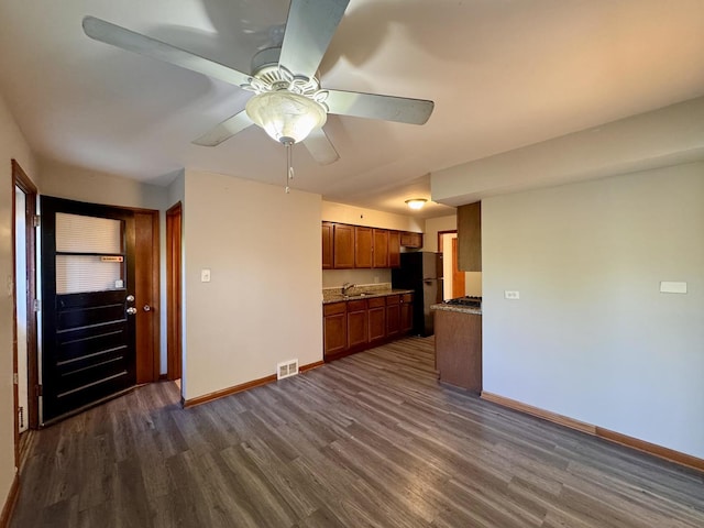 16850 School St, South Holland, IL 60473 - unfurnished living room featuring dark wood-type flooring and ceiling fan