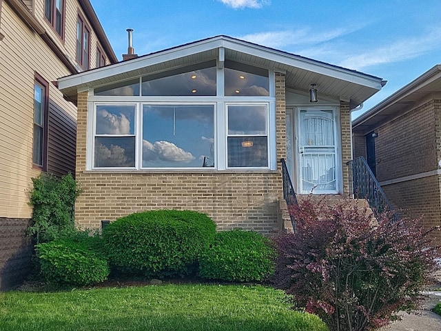 1747 E 92nd Pl, Chicago, IL 60617 - view of side of home featuring brick siding and a sunroom