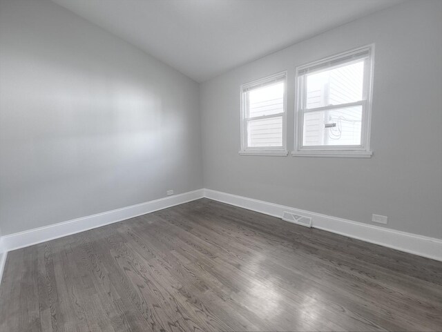 1747 E 92nd Pl, Chicago, IL 60617 - empty room with lofted ceiling and dark wood finished floors