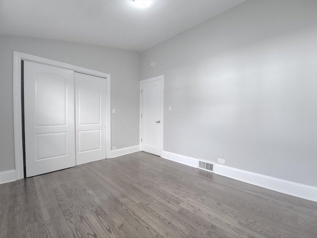 1747 E 92nd Pl, Chicago, IL 60617 - unfurnished bedroom with dark wood-type flooring and a closet