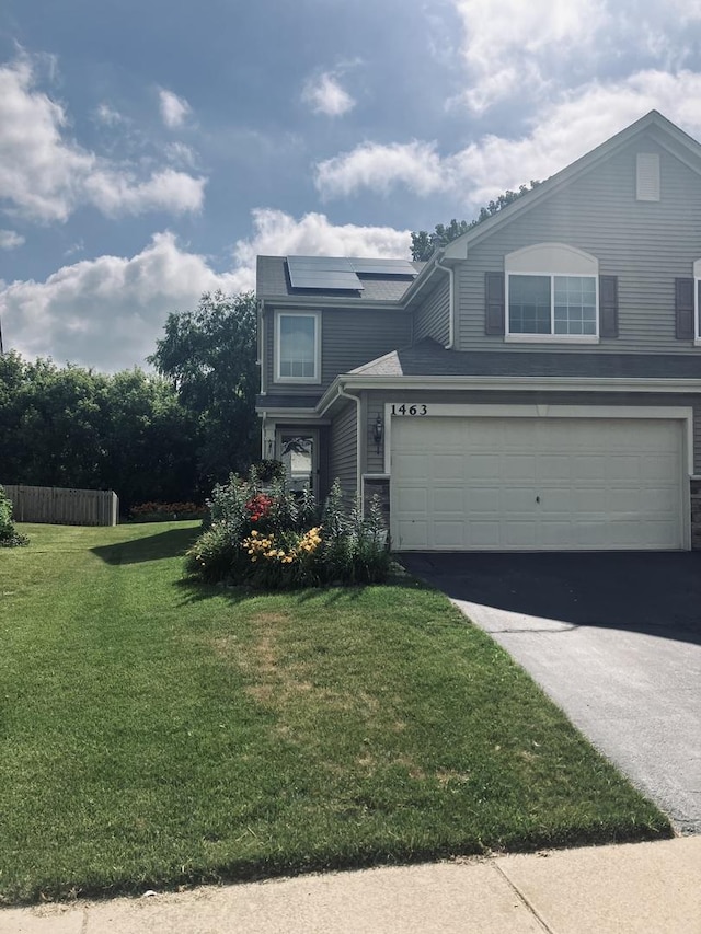 1463 Carlisle Ln, Hampshire, IL 60140 - traditional-style home with asphalt driveway, an attached garage, and solar panels