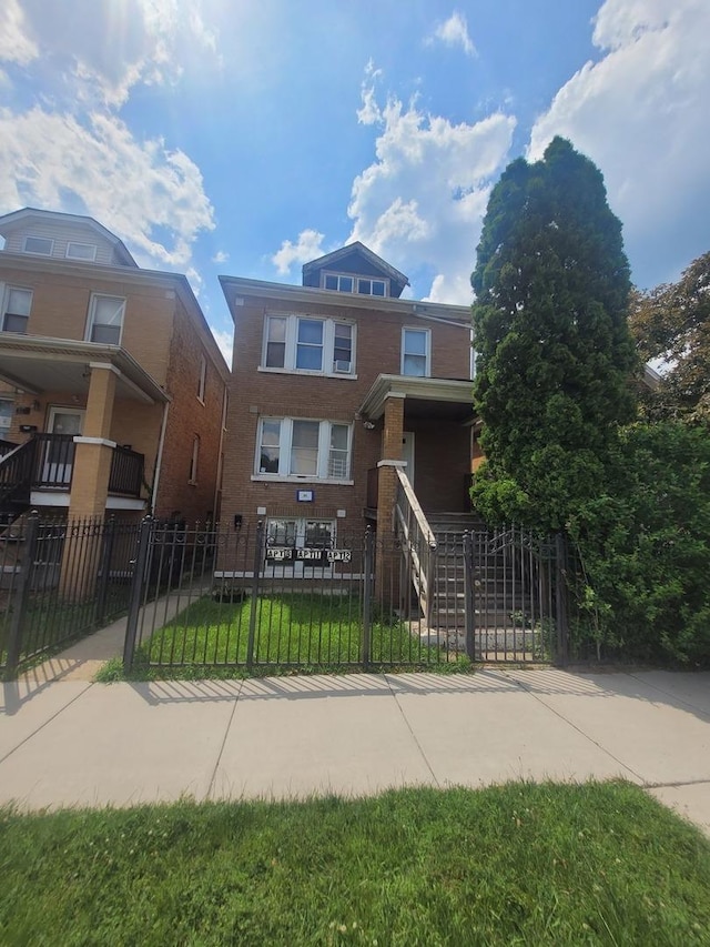 8344 S Mackinaw Ave, Chicago, IL 60617 - view of front of home with a fenced front yard, brick siding, and a gate