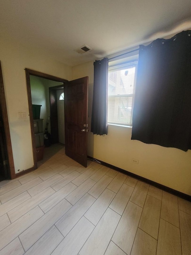 8344 S Mackinaw Ave, Chicago, IL 60617 - spare room featuring wood tiled floors and baseboards