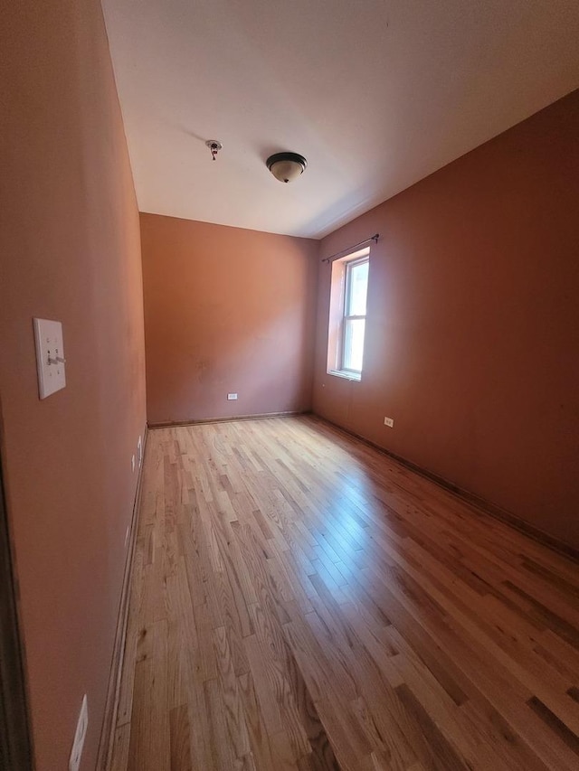 8344 S Mackinaw Ave, Chicago, IL 60617 - unfurnished room featuring wood finished floors and a pendent fire sprinkler