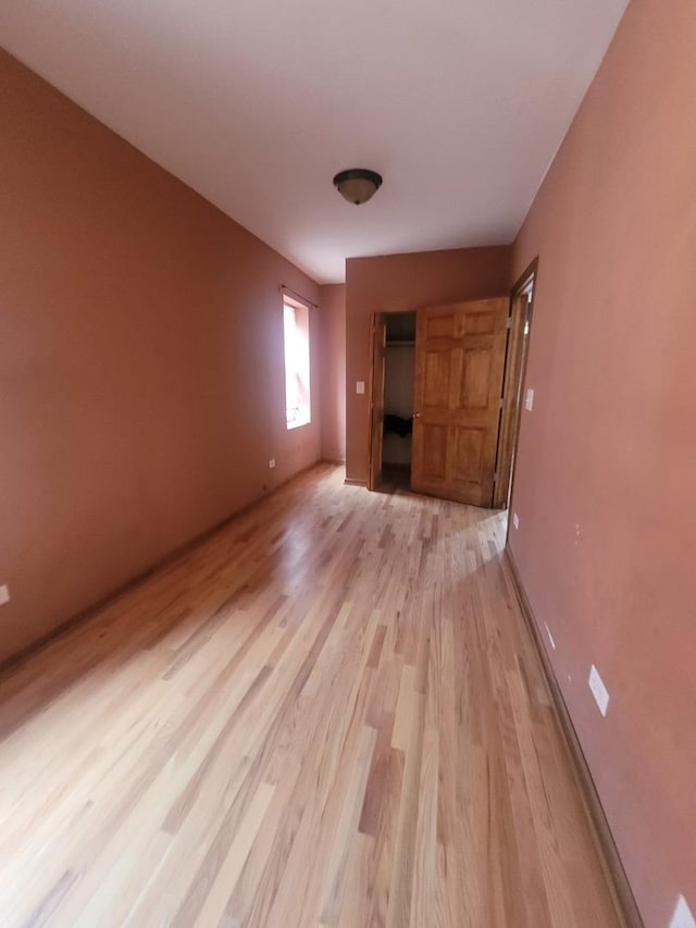 8344 S Mackinaw Ave, Chicago, IL 60617 - unfurnished living room featuring light wood finished floors and baseboards