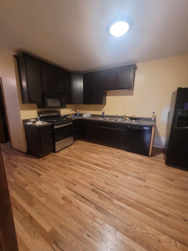 8344 S Mackinaw Ave, Chicago, IL 60617 - kitchen featuring black appliances, light wood-type flooring, and dark countertops