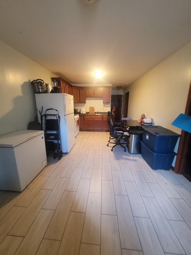 8344 S Mackinaw Ave, Chicago, IL 60617 - kitchen featuring white appliances, light wood-type flooring, and brown cabinets