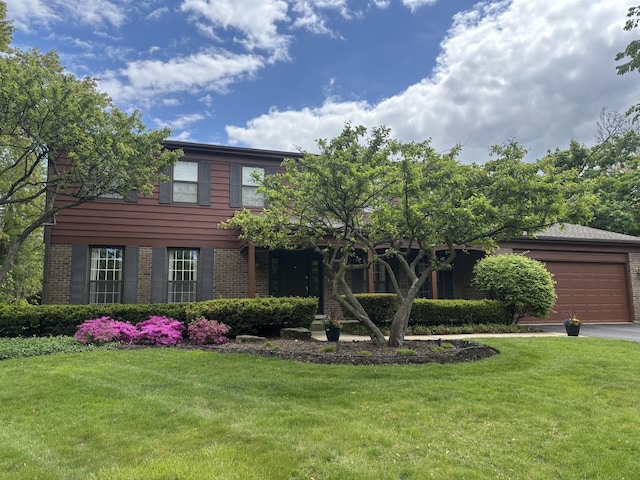 375 Sunset Dr, Northfield, IL 60093 - view of front facade featuring brick siding, an attached garage, and a front yard