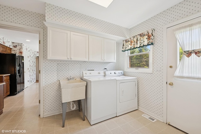 375 Sunset Dr, Northfield, IL 60093 - laundry room featuring wallpapered walls, cabinet space, washing machine and clothes dryer, and light tile patterned flooring