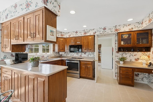 375 Sunset Dr, Northfield, IL 60093 - kitchen featuring stainless steel electric range, wallpapered walls, black microwave, a peninsula, and light countertops