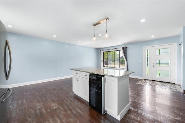 3920 Greenbay Dr, Hanover Park, IL 60133 - kitchen with wine cooler, dark wood finished floors, open floor plan, stainless steel fridge, and light stone counters