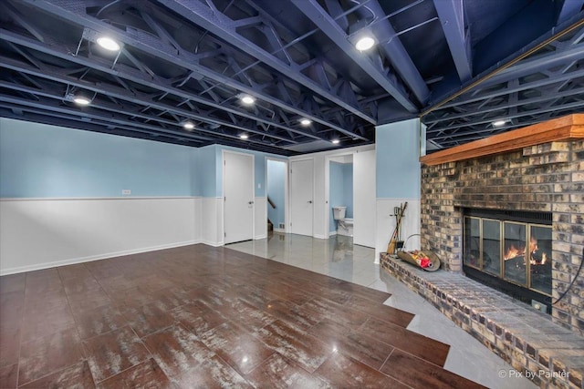 3920 Greenbay Dr, Hanover Park, IL 60133 - finished basement featuring a fireplace, wood finished floors, and a wainscoted wall