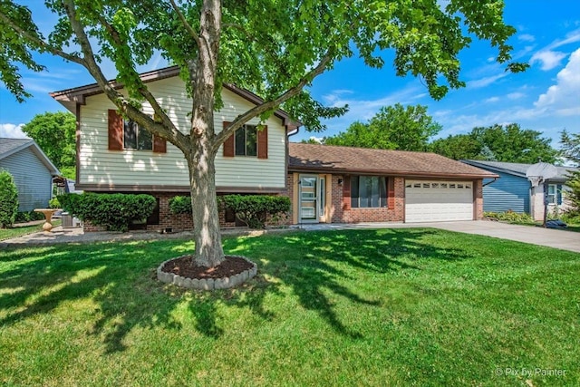 3920 Greenbay Dr, Hanover Park, IL 60133 - split level home featuring a garage, driveway, brick siding, and a front yard