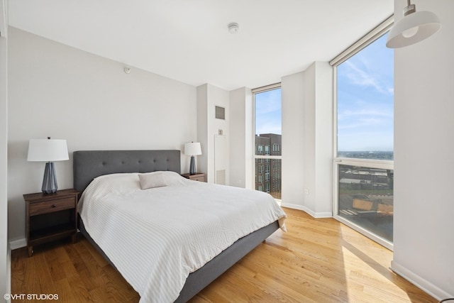 645 N Kingsbury St Unit 2002, Chicago, IL 60654 - bedroom with multiple windows, expansive windows, and wood finished floors