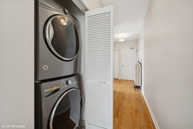 645 N Kingsbury St Unit 2002, Chicago, IL 60654 - laundry room featuring stacked washing machine and dryer and light wood-style flooring
