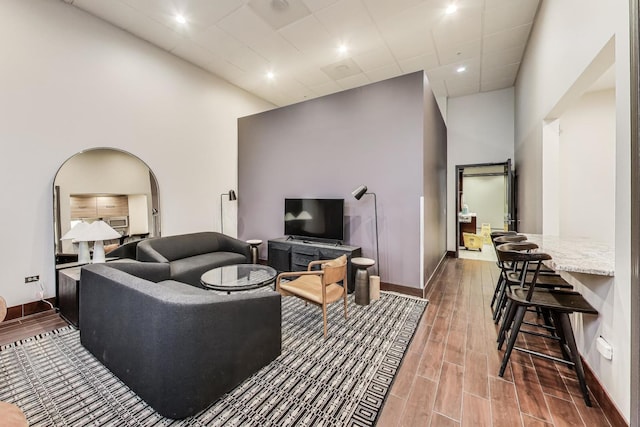 645 N Kingsbury St Unit 2002, Chicago, IL 60654 - living room featuring a towering ceiling, wood finished floors, and arched walkways
