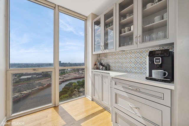 645 N Kingsbury St Unit 2002, Chicago, IL 60654 - bar featuring plenty of natural light, light wood finished floors, backsplash, and a water view