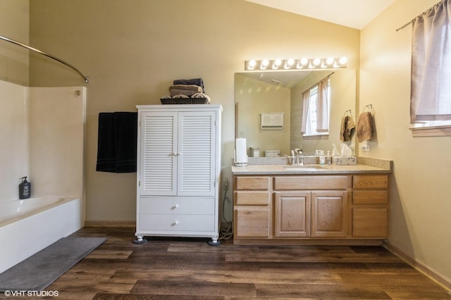 25637 S Fieldstone Ct, Channahon, IL 60410 - bathroom with lofted ceiling, wood finished floors, vanity, and tub / shower combination