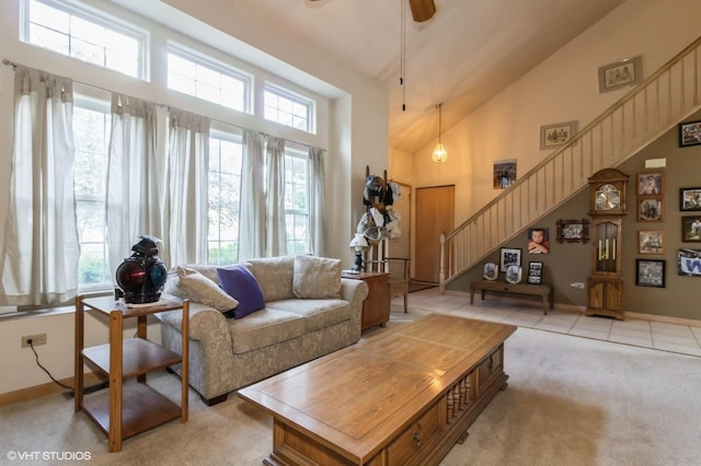 25637 S Fieldstone Ct, Channahon, IL 60410 - living room featuring healthy amount of natural light, stairway, high vaulted ceiling, a ceiling fan, and light carpet