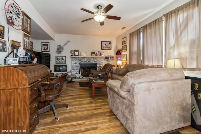 25637 S Fieldstone Ct, Channahon, IL 60410 - living room with ceiling fan, light wood-style floors, and a fireplace with raised hearth