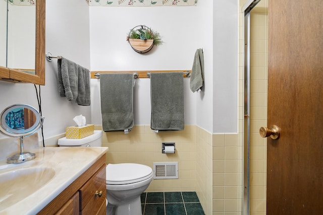 9108 Windsor Dr, Palos Hills, IL 60465 - bathroom with vanity, tile patterned flooring, an enclosed shower, tile walls, and wainscoting