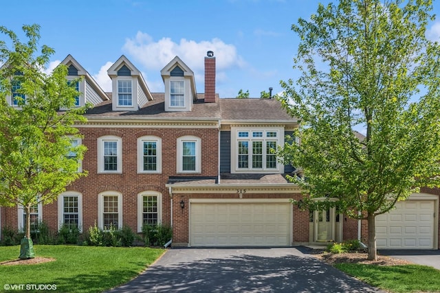 315 Princeton Ln, Glenview, IL 60026 - colonial-style house with driveway, a chimney, a front yard, a garage, and brick siding