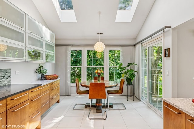 315 Princeton Ln, Glenview, IL 60026 - dining room with vaulted ceiling, a skylight, healthy amount of natural light, and light tile patterned floors