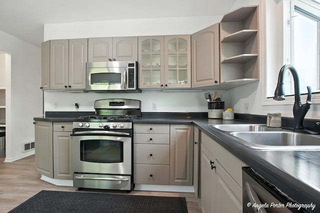 5535 Wonder Woods Dr, Wonder Lake, IL 60097 - kitchen with stainless steel appliances, dark countertops, light wood-style floors, glass insert cabinets, and open shelves