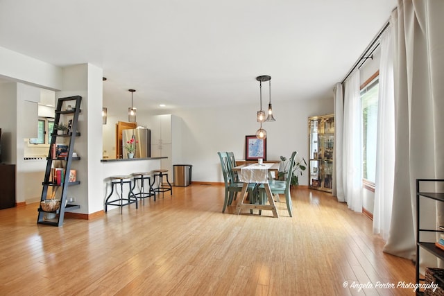 4725 Winnebago Dr, Wonder Lake, IL 60097 - dining room featuring light wood-style flooring and baseboards