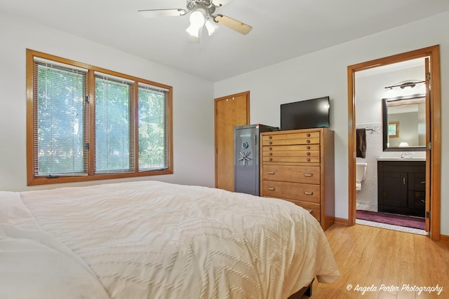 4725 Winnebago Dr, Wonder Lake, IL 60097 - bedroom with light wood finished floors, ensuite bathroom, a ceiling fan, and a fireplace