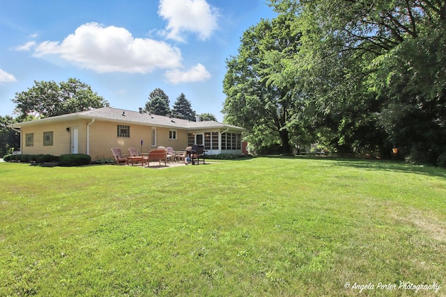 4725 Winnebago Dr, Wonder Lake, IL 60097 - rear view of property featuring a yard, a patio, and brick siding
