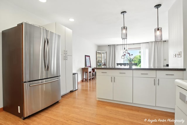 4725 Winnebago Dr, Wonder Lake, IL 60097 - kitchen with freestanding refrigerator, light wood finished floors, white cabinetry, recessed lighting, and hanging light fixtures