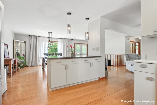 4725 Winnebago Dr, Wonder Lake, IL 60097 - kitchen with white cabinets, light wood-style flooring, decorative light fixtures, and a peninsula