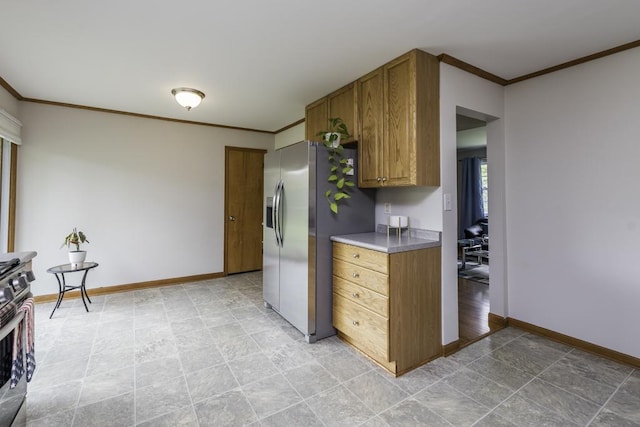 22271 W Terry Dr S, Lake Villa, IL 60046 - kitchen featuring stainless steel appliances, ornamental molding, brown cabinetry, and light stone finish floors