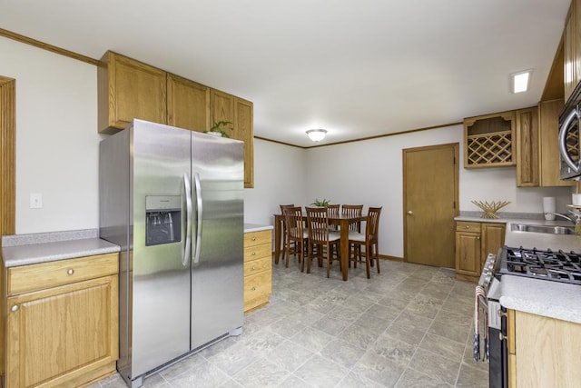 22271 W Terry Dr S, Lake Villa, IL 60046 - kitchen with stainless steel appliances, light countertops, ornamental molding, brown cabinets, and stone finish flooring