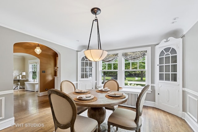2539 Marcy Ave, Evanston, IL 60201 - dining area featuring arched walkways, light wood finished floors, and ornamental molding