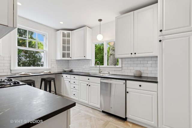 2539 Marcy Ave, Evanston, IL 60201 - kitchen featuring dishwasher, dark countertops, white cabinets, decorative backsplash, and recessed lighting