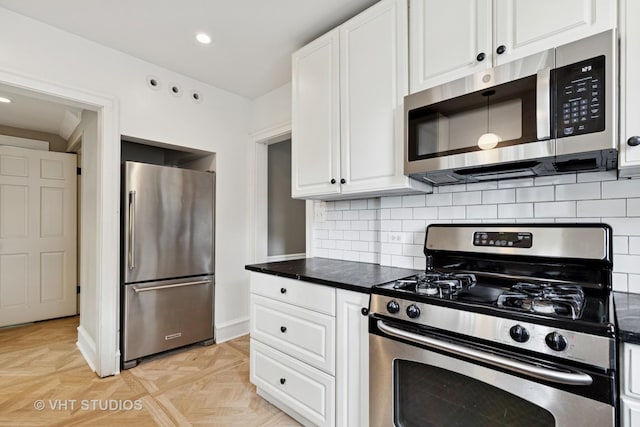2539 Marcy Ave, Evanston, IL 60201 - kitchen featuring stainless steel appliances, white cabinetry, dark countertops, decorative backsplash, and recessed lighting