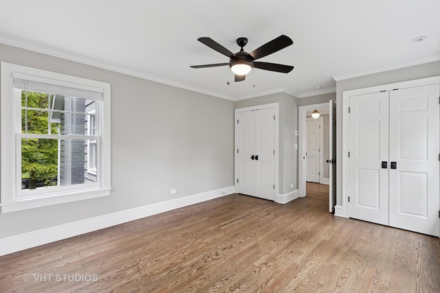 2539 Marcy Ave, Evanston, IL 60201 - unfurnished bedroom featuring wood finished floors, two closets, ornamental molding, and a ceiling fan