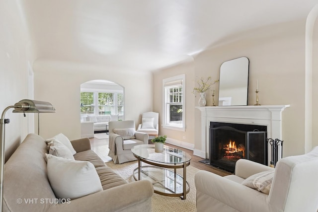 2539 Marcy Ave, Evanston, IL 60201 - living room featuring a warm lit fireplace, wood finished floors, and arched walkways