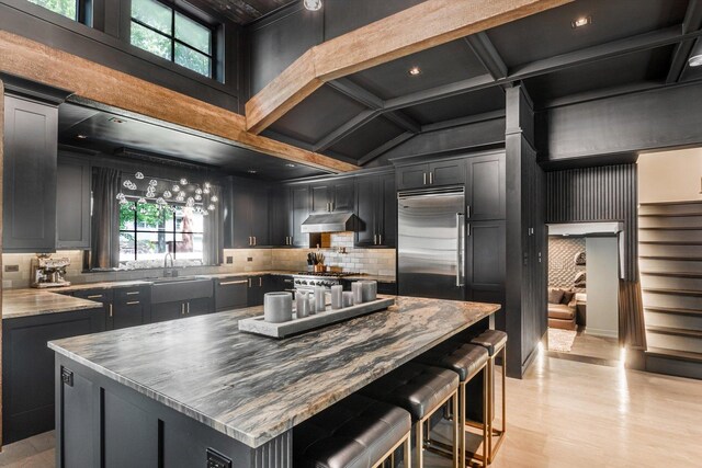 400 S Rose Ave, Park Ridge, IL 60068 - kitchen featuring built in refrigerator, tasteful backsplash, a breakfast bar area, a center island, and high vaulted ceiling