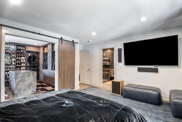 400 S Rose Ave, Park Ridge, IL 60068 - bedroom featuring stacked washer / drying machine, a barn door, recessed lighting, wood finished floors, and connected bathroom