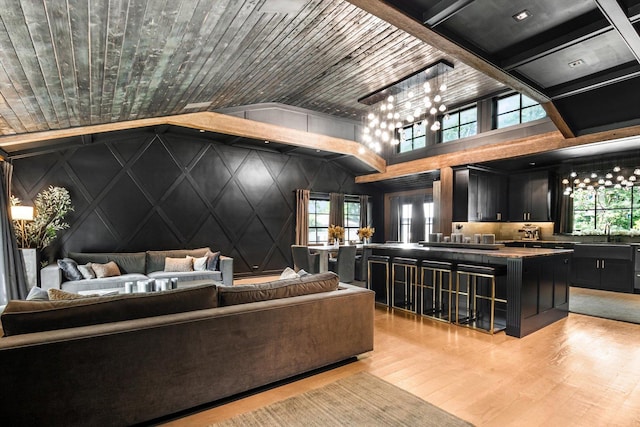 400 S Rose Ave, Park Ridge, IL 60068 - living room with plenty of natural light, light wood-type flooring, a chandelier, a decorative wall, and vaulted ceiling