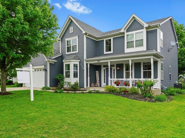 210 Woodford Rd, Oswego, IL 60543 - traditional home with covered porch, a garage, a front yard, and driveway