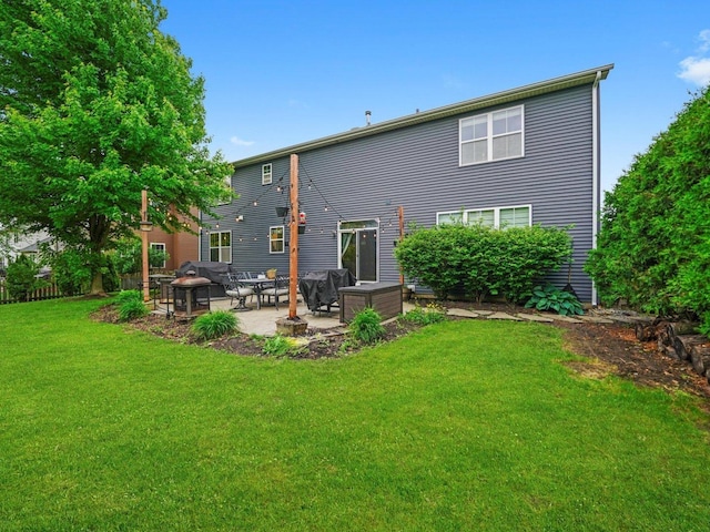 210 Woodford Rd, Oswego, IL 60543 - rear view of house with a patio area and a lawn